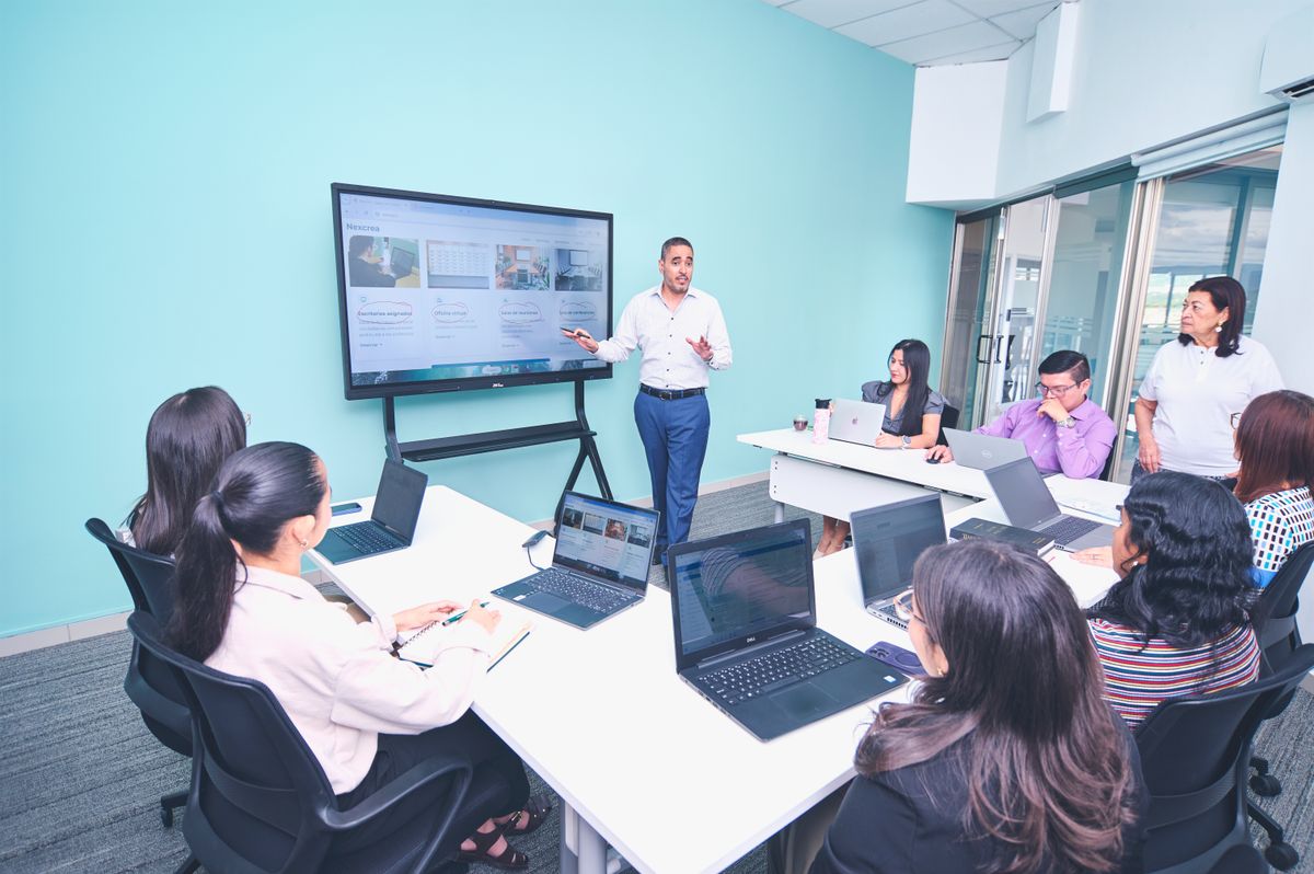 Team engaged in a presentation at a modern office using digital technology