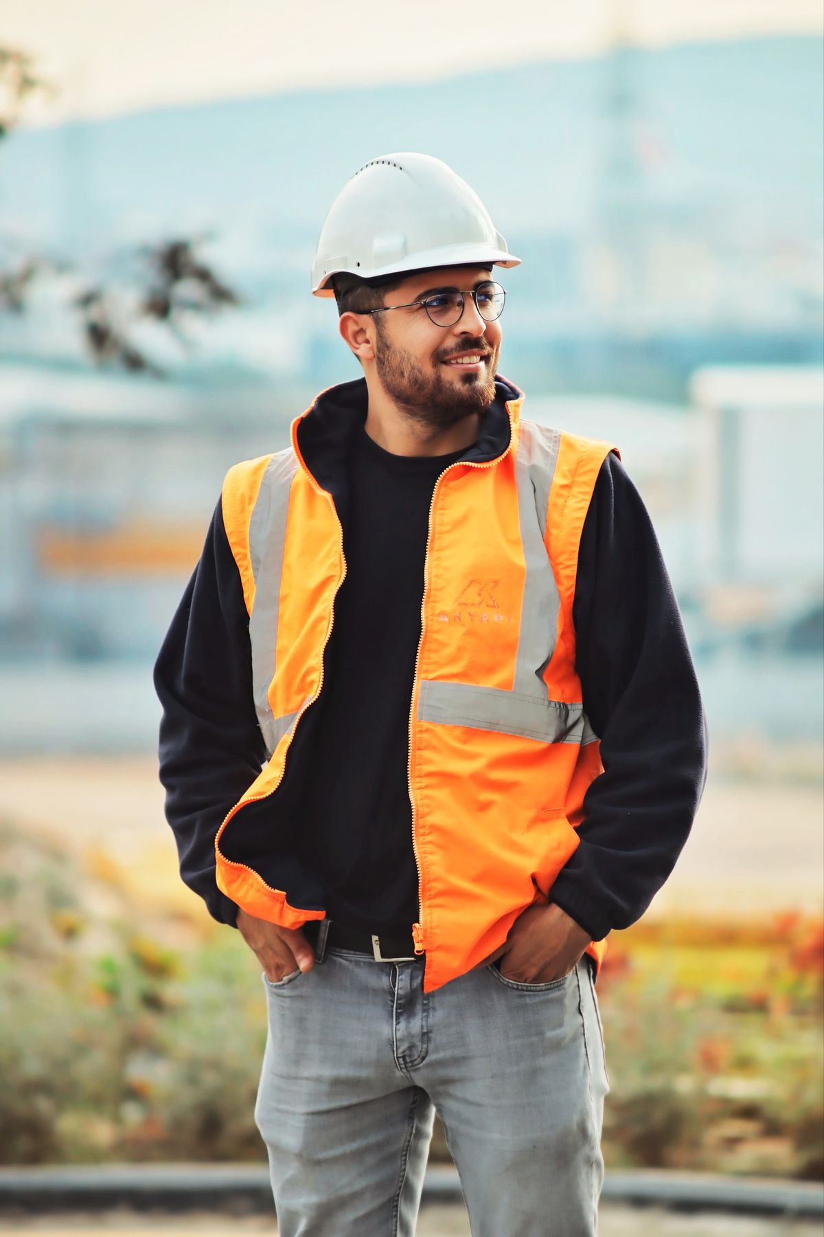 Smiling construction worker wearing safety vest and helmet