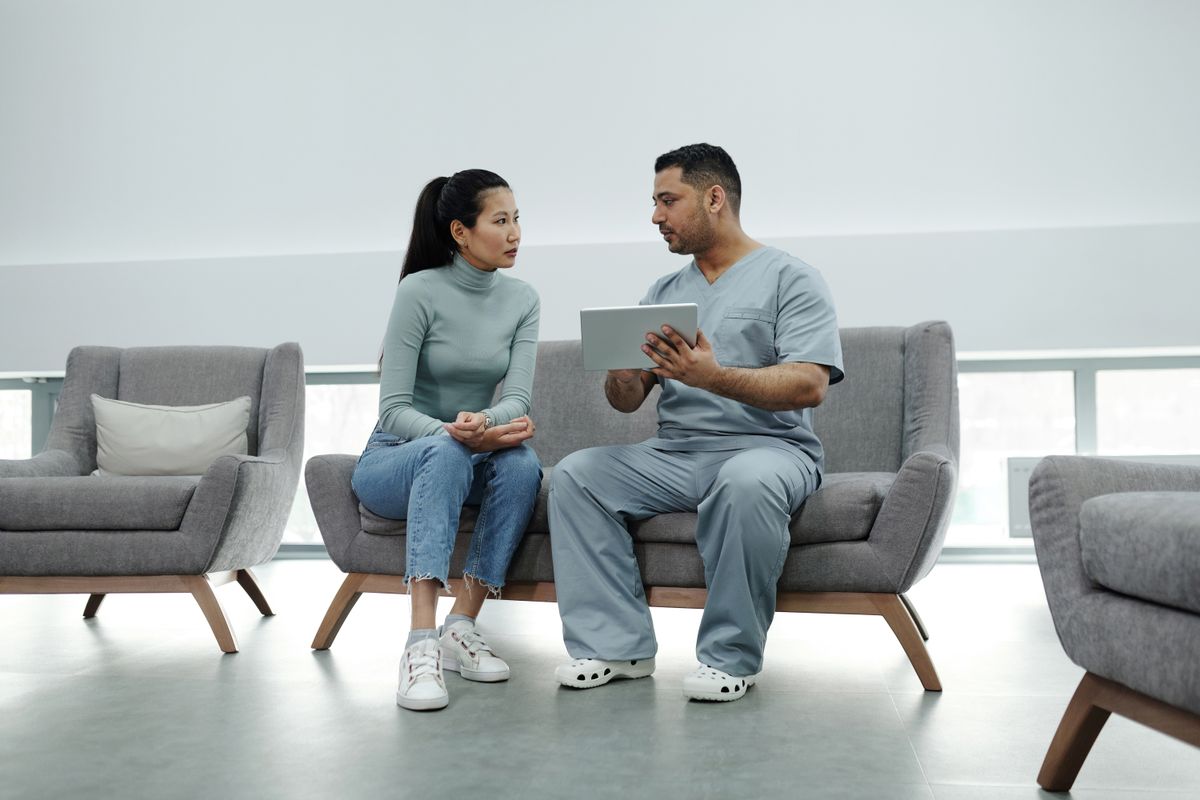 Healthcare provider consulting a patient with a tablet