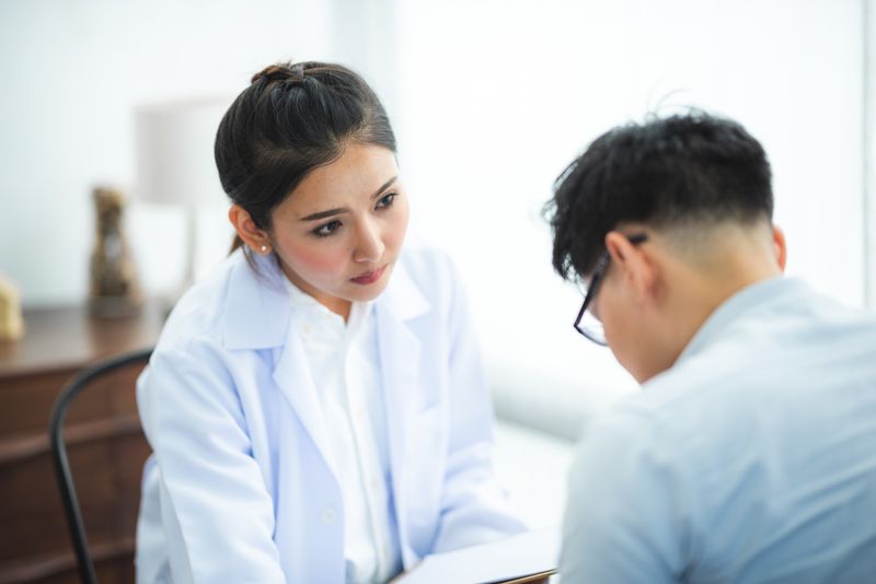 A doctor attentively listens to a patient during a medical consultation