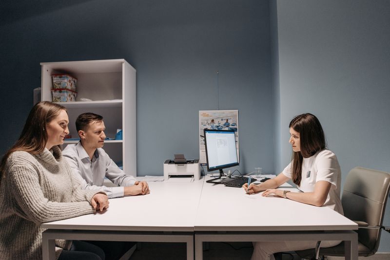 A couple consulting with a doctor in a medical office for a health check-up