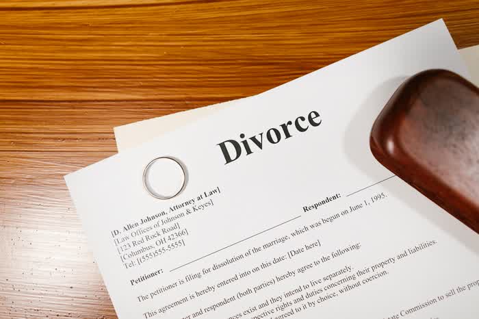 Divorce papers and a ring on a desk