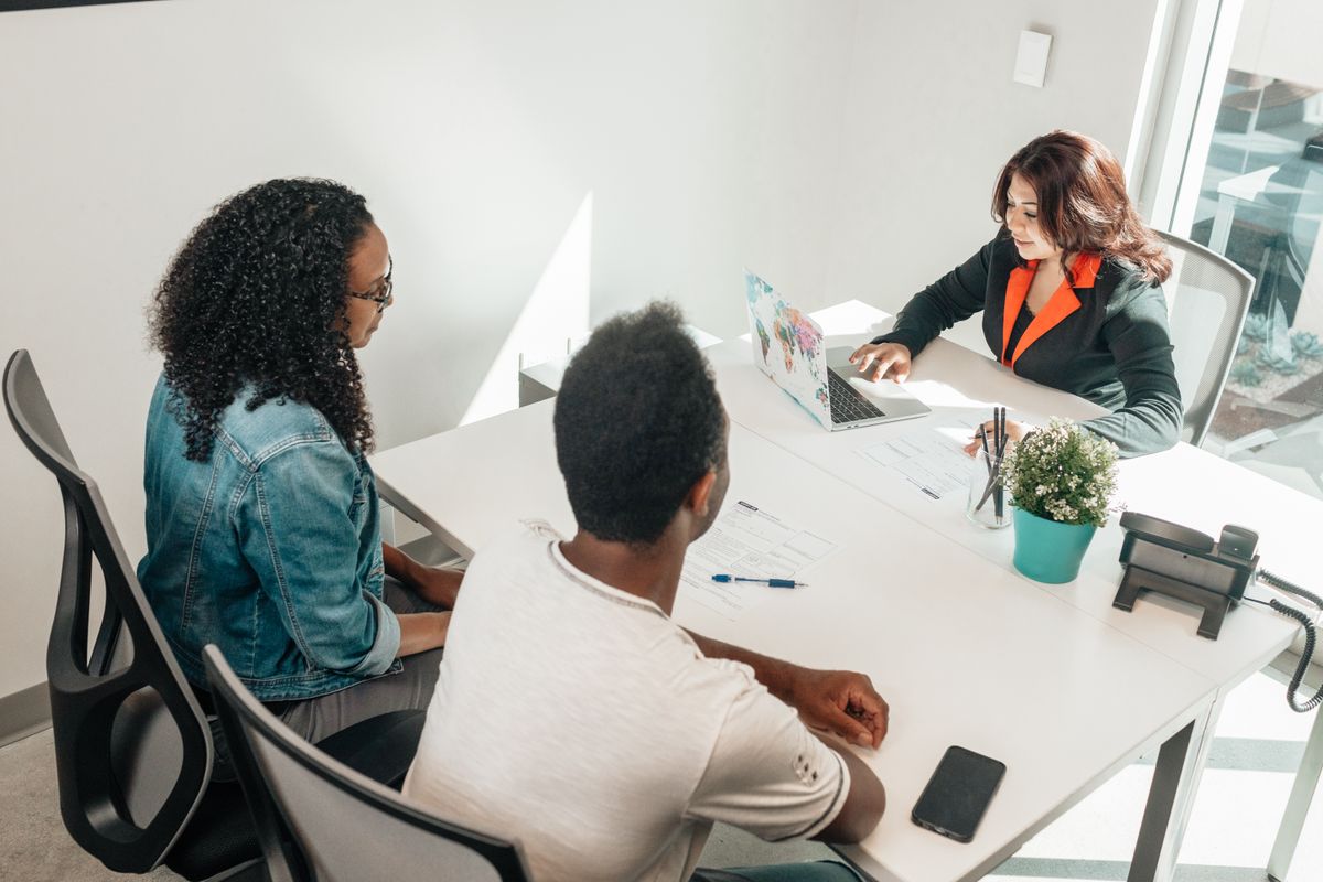 Diverse professionals having a business meeting indoors around a table